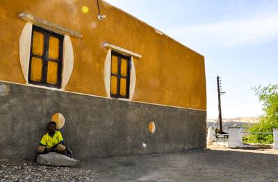 A Nubian boy, sitting outside his grandfather's house, Heyssah Island, Aswan, Egypt